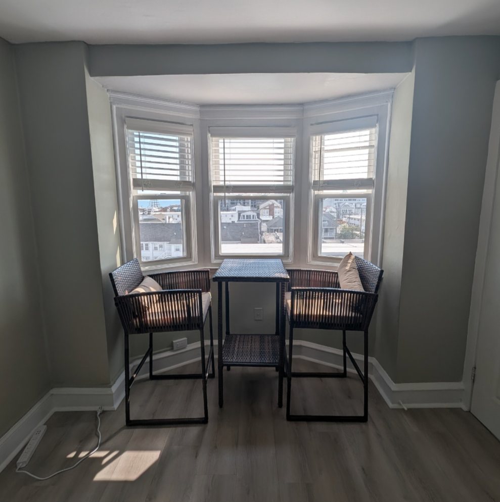 Bay Window Sitting Nook — Trim, flooring, and paint bringing a bay-window nook back to life.
