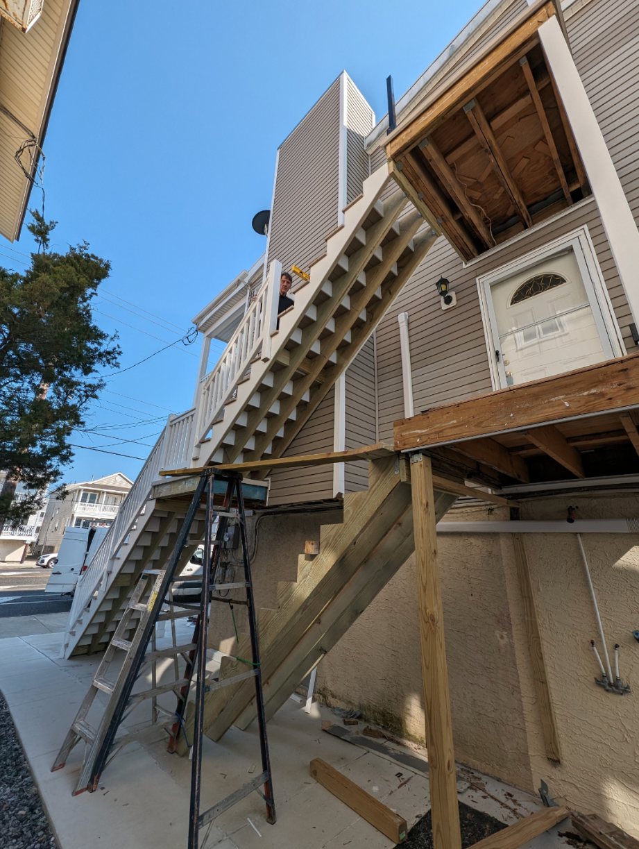 Exterior Stairs & Deck — Second-story access stairs and deck framing tied into the structure.